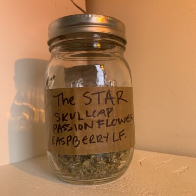 a jar of herbs labelled "the star- skullcap, passionflower, raspberry leaf"